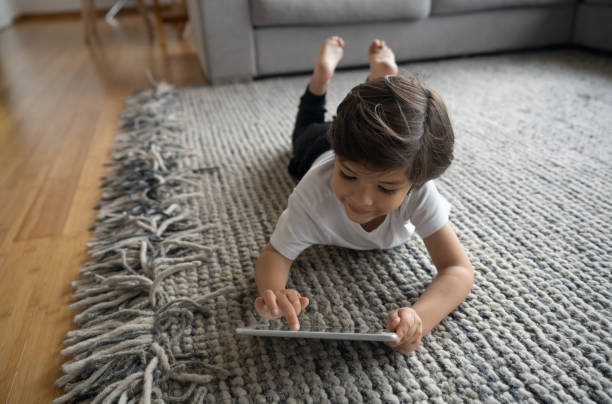 Kid laying on rug | Clark Dunbar Flooring Superstore